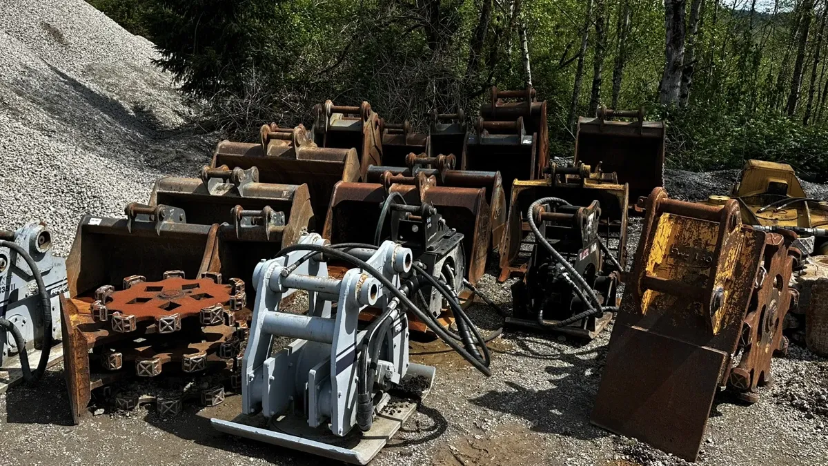 Excavator attachments including buckets, thumbs, augers, and breakers