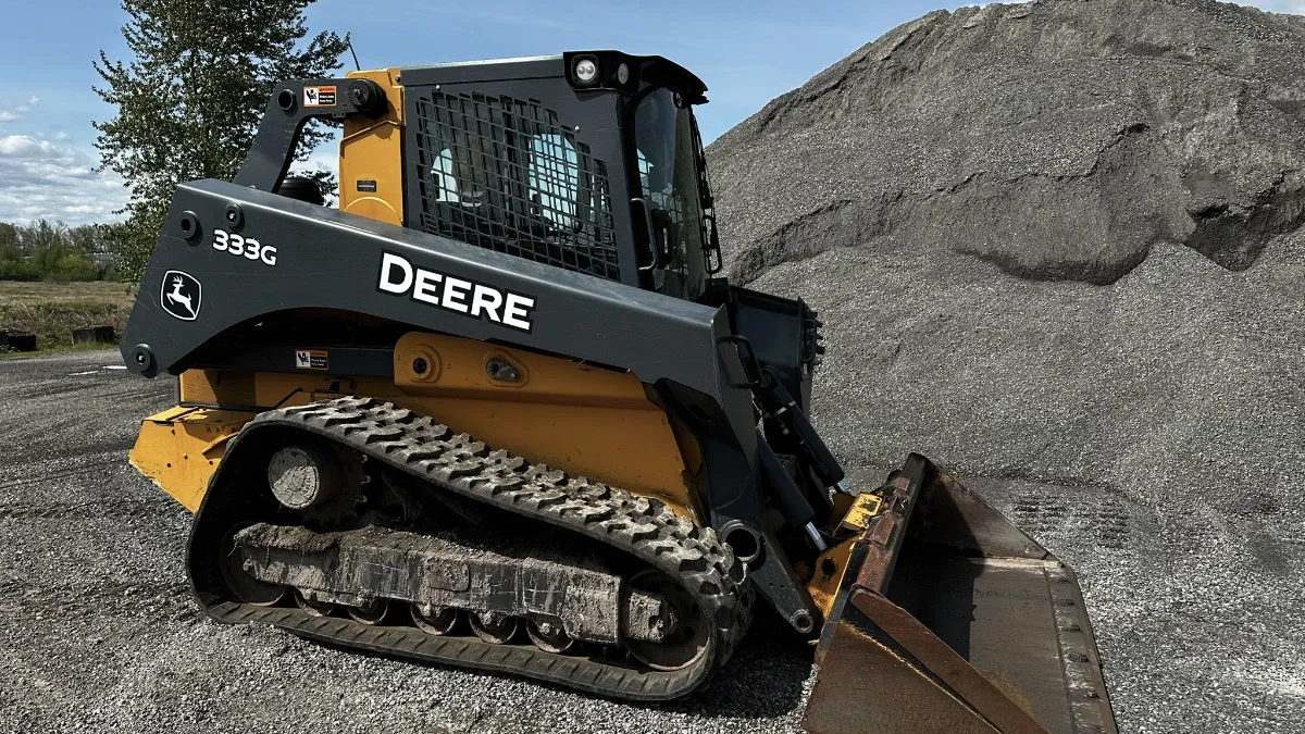 Skid steer used for grading, loading, and material handling